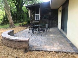 A stone patio with a retaining wall