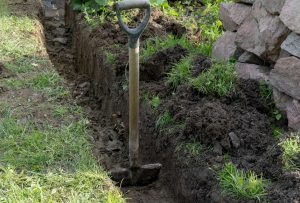 Digging drainage system in yard.
